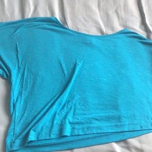 Blue crop top with one shoulder showing